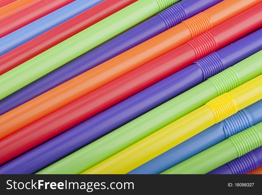 Plastic tubes of different colors in the background.