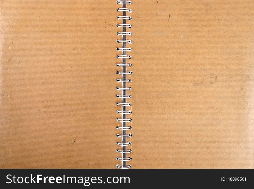 Blank grungy spiral cardboard notebook. Blank grungy spiral cardboard notebook