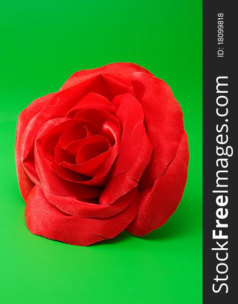 Red silk rose for design on green background. Red silk rose for design on green background