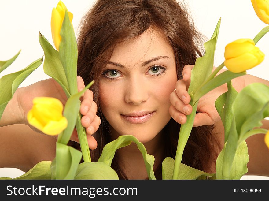 Beautiful brunette girl with fresh yellow tulips. Beautiful brunette girl with fresh yellow tulips