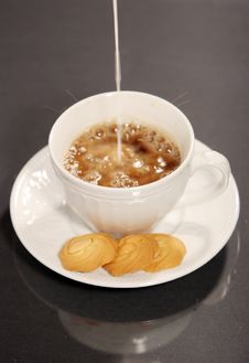 Pouring Milk Into Coffee And Cookies Stock Photos Pouring Milk Into Coffee And Cookies Stock Photos