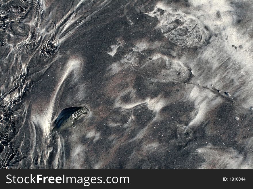 Black sand on a beach, great for background or texture