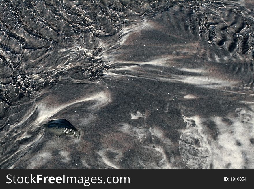 Black sand on a beach, great for background or texture