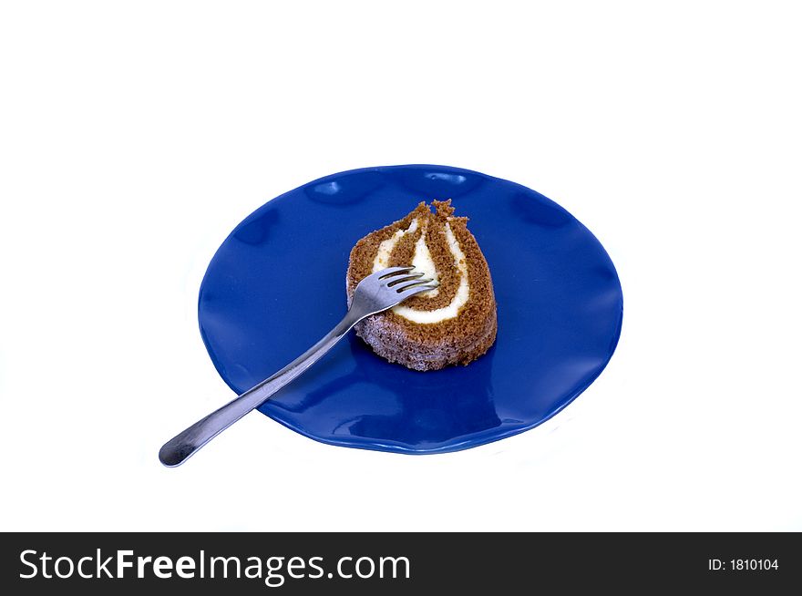 Pumpkin roll on blue plate with fork