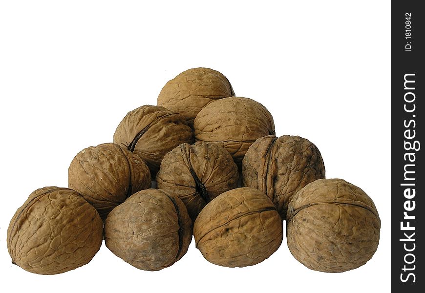 On a photo walnuts in the form of a triangle. The photo is isolated. The photo is made in Ukraine. On a photo walnuts in the form of a triangle. The photo is isolated. The photo is made in Ukraine.