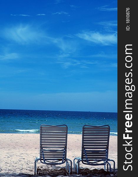 Deck chairs on the beach with sea and blue sky. Deck chairs on the beach with sea and blue sky