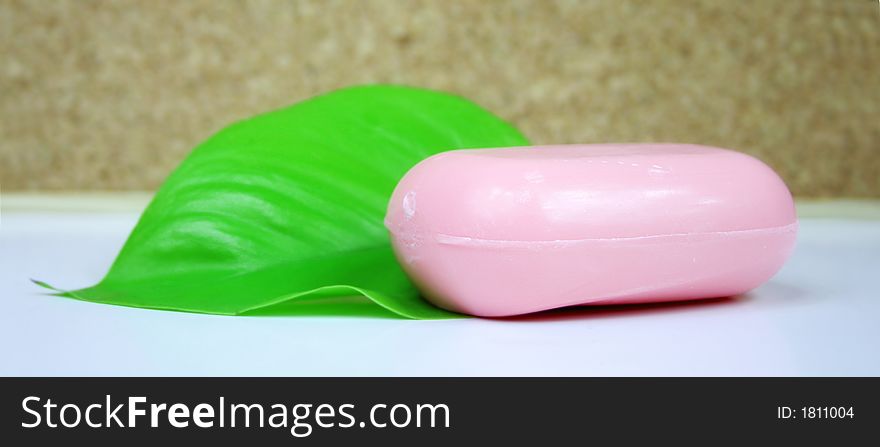 A green leaf with pink soap - wellness - spa. A green leaf with pink soap - wellness - spa