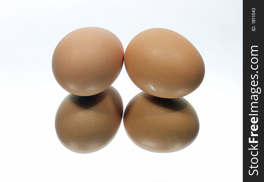 Two eggs with pure reflection on mirror