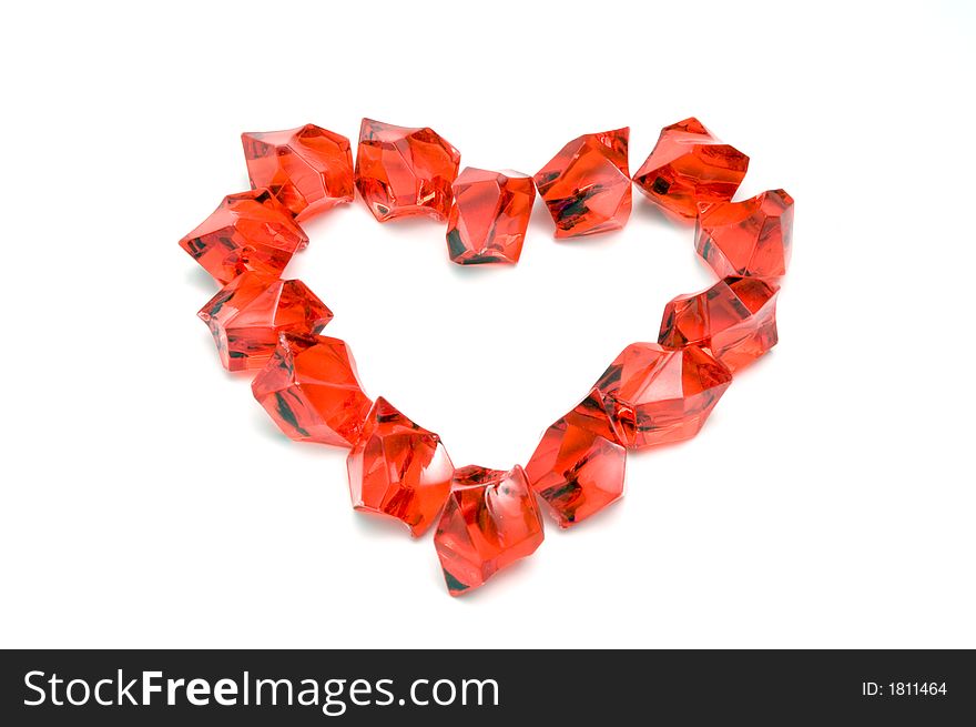 Close-up of a heart shaped of red stones on white. Close-up of a heart shaped of red stones on white