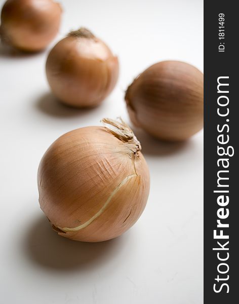 Four onions on white background