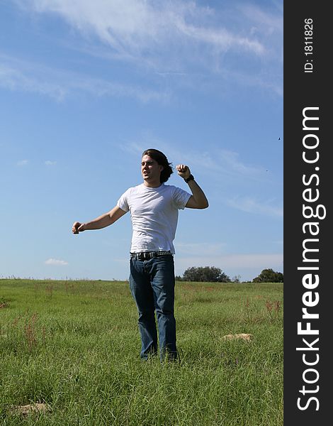 Photo of a young man standing in a field ~Happy Hill Road~. Photo of a young man standing in a field ~Happy Hill Road~