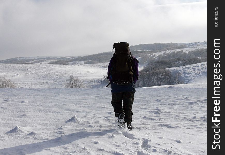 Men is walking in snows of Carabie's plateau in Crimean Mountains (Ukraine). Men is walking in snows of Carabie's plateau in Crimean Mountains (Ukraine)