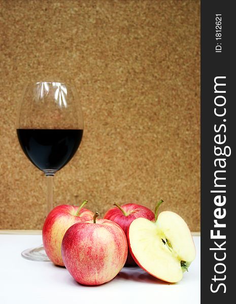 Red wine in a glass with four apple. Red wine in a glass with four apple