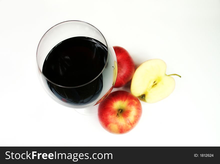 Red wine in a glass with four apple. Red wine in a glass with four apple