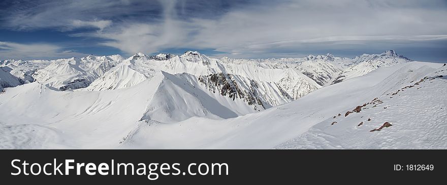 Mountain peaks in Georgia, near Gudauri ski resort.  Panoramic view is from Sutzelly Mountain. Mountain peaks in Georgia, near Gudauri ski resort.  Panoramic view is from Sutzelly Mountain.