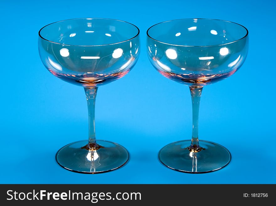 Two glasses on blue background