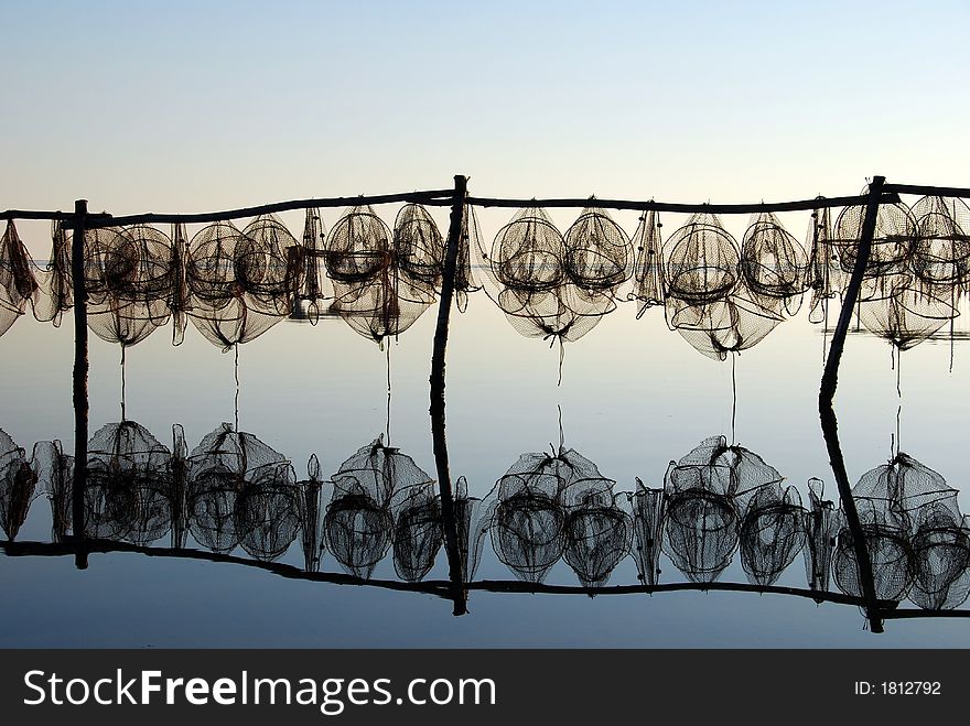 Fishing traps against lovely reflection at sunset. Fishing traps against lovely reflection at sunset