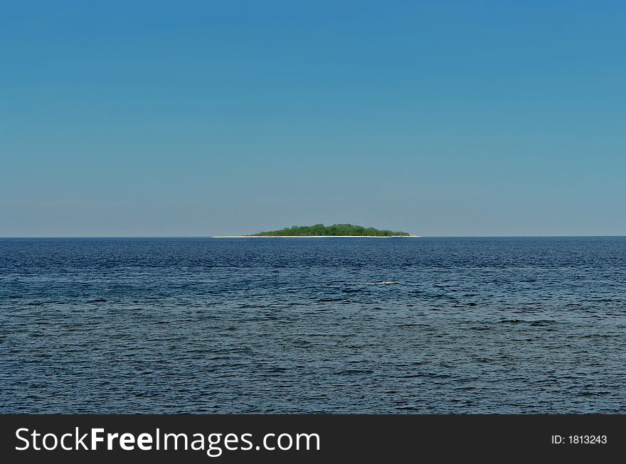 Tropical island in exotic sea. Very simple concept of resort, hide-away, leisure, relax, relaxation. Perfect horizon. Can be used as horizontal banner. Tropical island in exotic sea. Very simple concept of resort, hide-away, leisure, relax, relaxation. Perfect horizon. Can be used as horizontal banner.