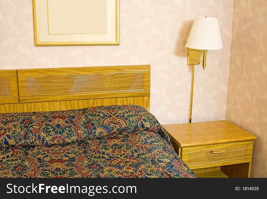 Hotel room showing the bed night stand and lamp