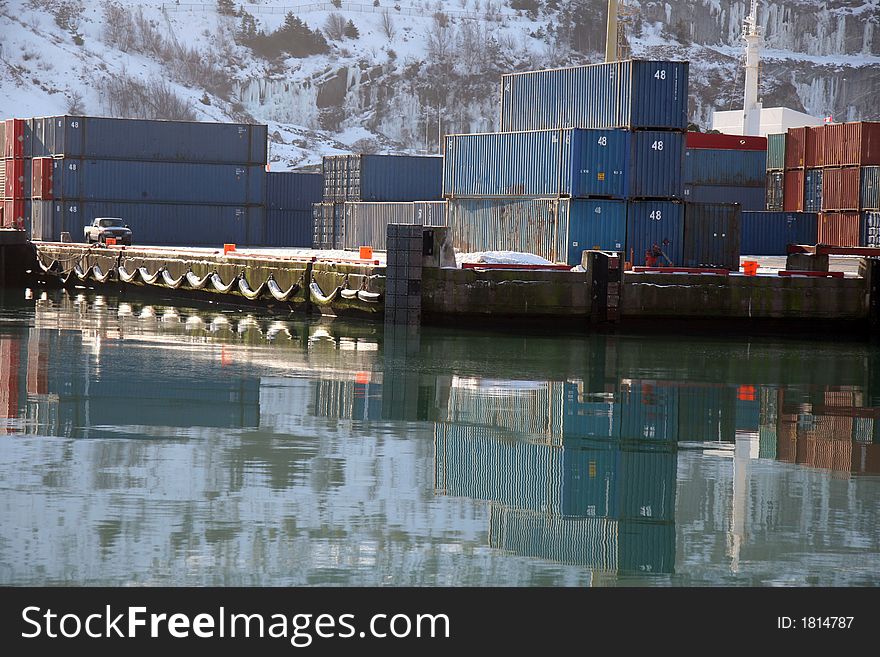 Shipping containers piled on a winter shipping dock. Shipping containers piled on a winter shipping dock.