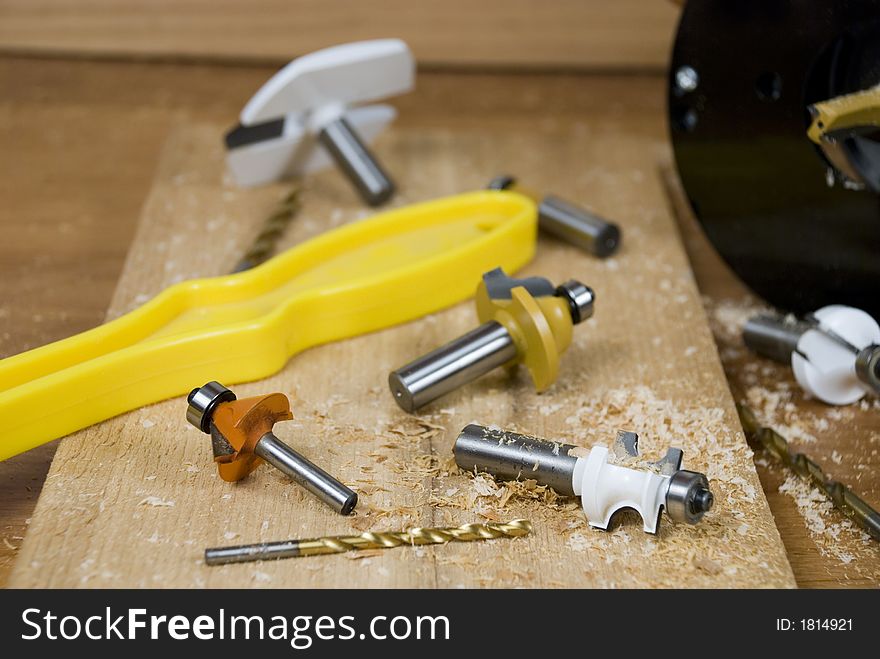 An assortment of router bits and woodworking tools.