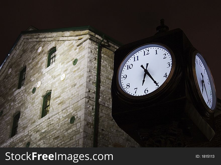 A clock in front of an old building in the Distillery District in Toronto. A clock in front of an old building in the Distillery District in Toronto