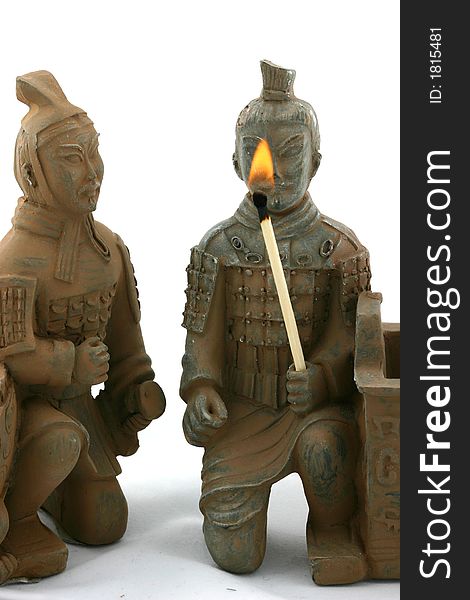 Two chinese warriors in traditional ancient uniforms holding torch and watching flame. Two chinese warriors in traditional ancient uniforms holding torch and watching flame