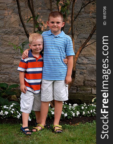 Two brothers standing together in front of a church.