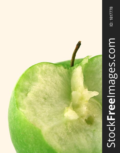 Bited green apple on a white background