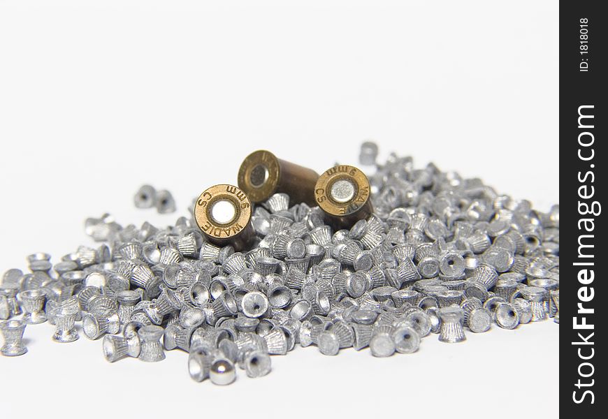 Macro of pneumatic and 9mm bullets on white background