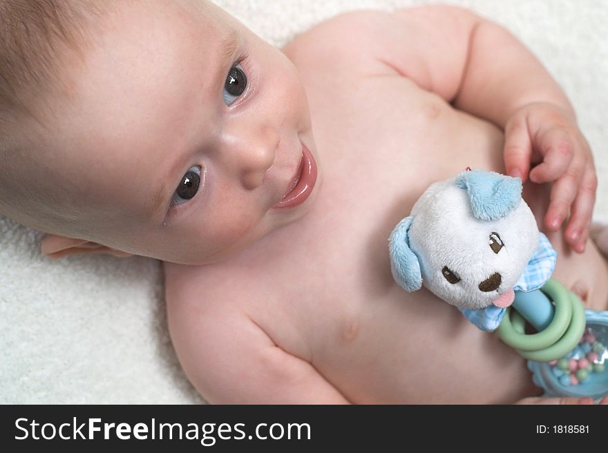 Image of baby holding a rattle. Image of baby holding a rattle