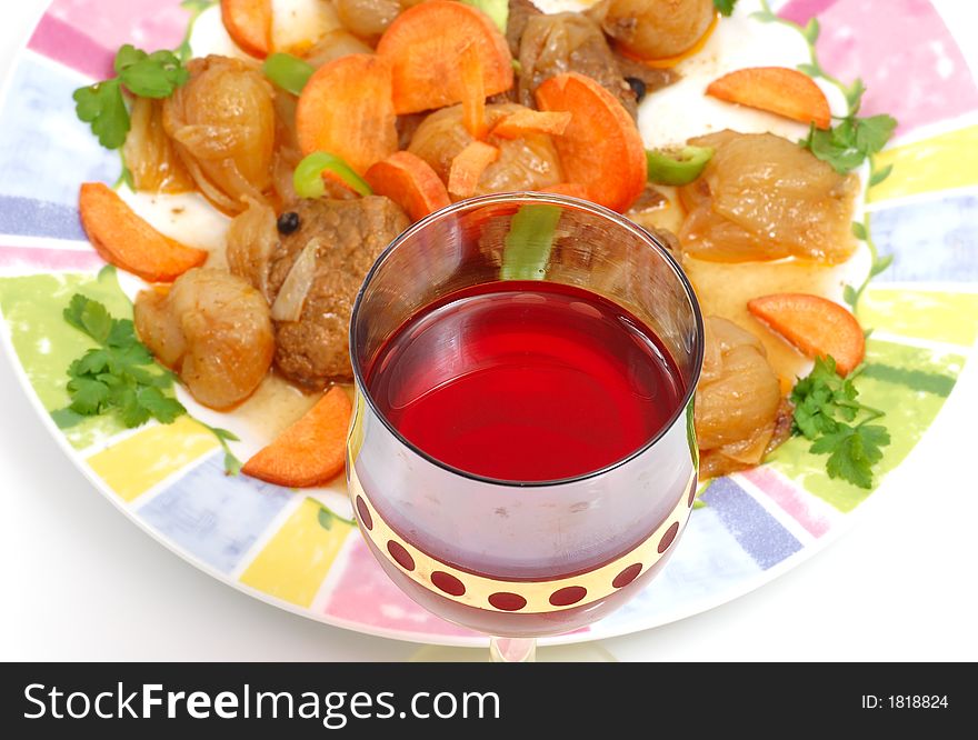 Meat dish with a red glass of wine (traditional   Greek receipe)