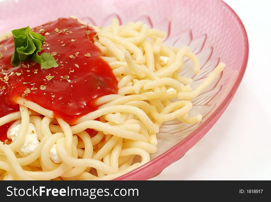 Spaghetti with tomato sauce in a red dish