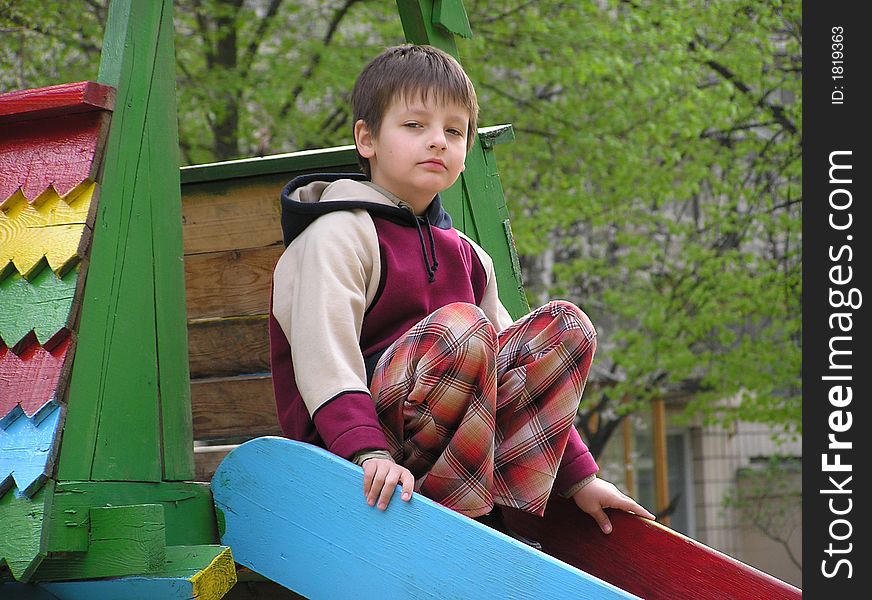 Boy playing ground red sitting calm. Boy playing ground red sitting calm