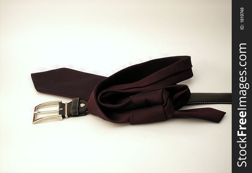 A managerial tie and a black fit belt with a silver buckle