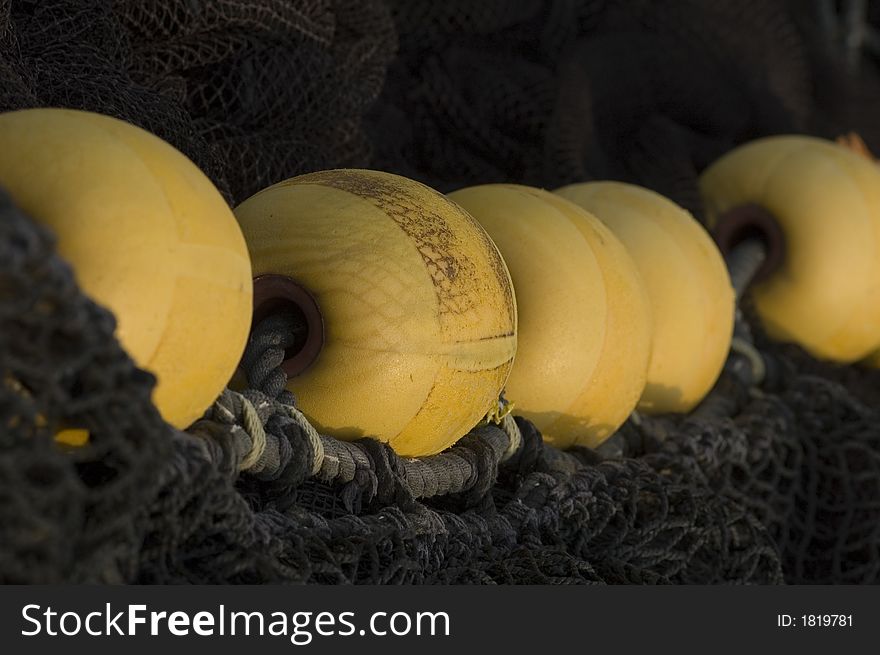 Yellow fishing float on black nets. Yellow fishing float on black nets