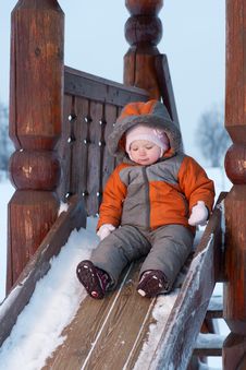 Cute Baby Prepare To Slide Down The Slides Royalty Free Stock Photo