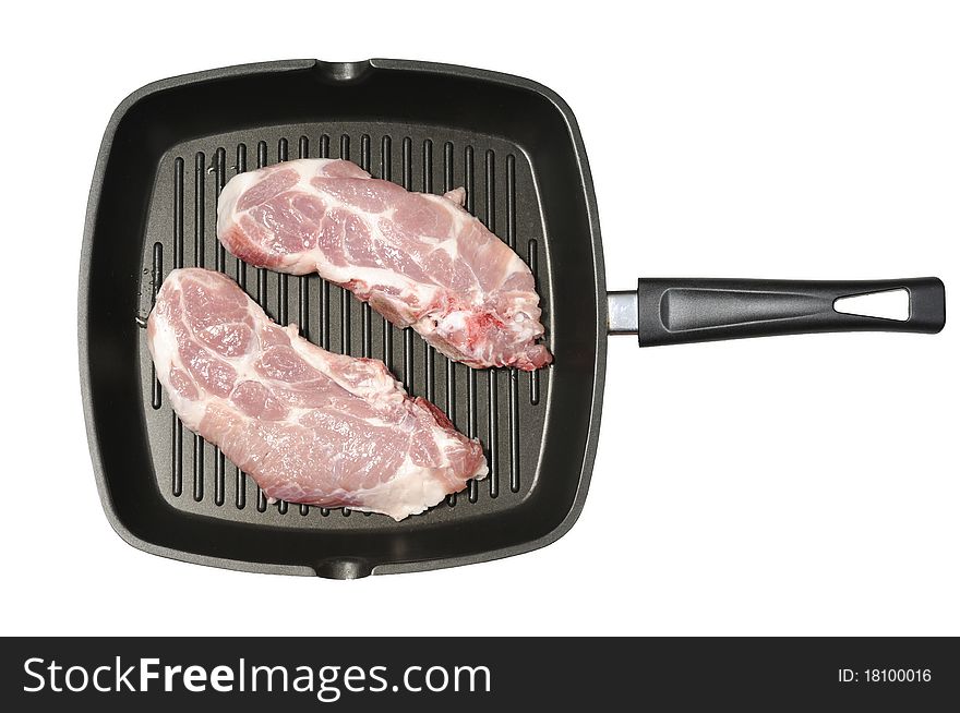 Frying pan with teflon coated rib with raw meat. Frying pan with teflon coated rib with raw meat