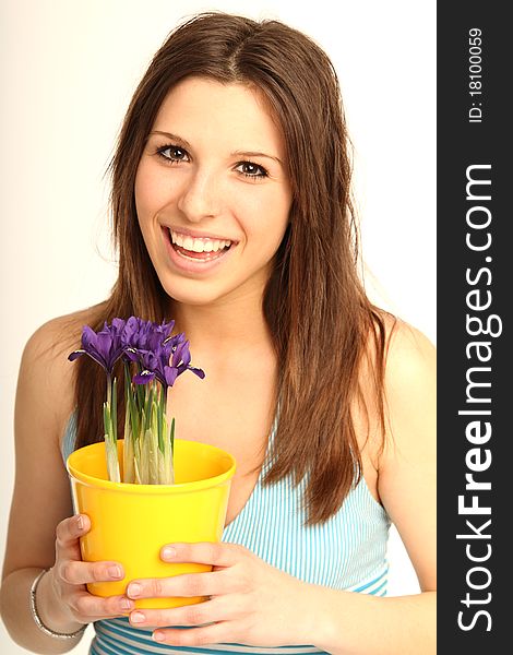 Beautiful brunette girl with fresh flowers in a flowerpot. Beautiful brunette girl with fresh flowers in a flowerpot