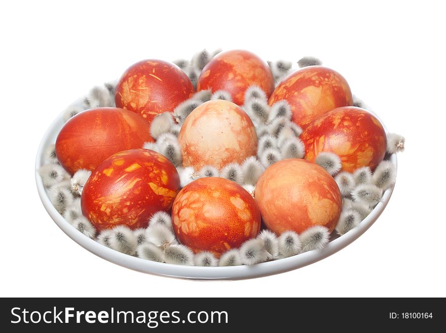 Red easter eggs and  pussy willow on plate with white isolated background. Red easter eggs and  pussy willow on plate with white isolated background