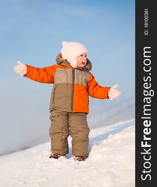 Adorable baby stay on mountain and gesticulate