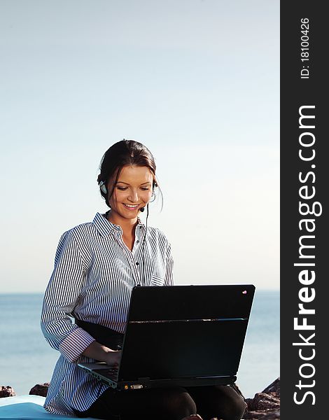 Woman with laptop sea background. Woman with laptop sea background