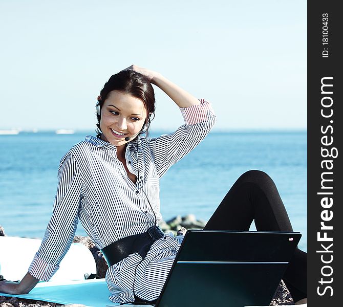 Woman with laptop sea background. Woman with laptop sea background