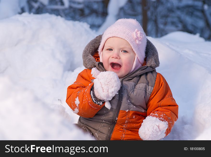 Adorable baby try to eat cold snow