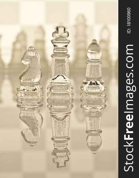 Beautiful glass chess on a white background. Photo taken in the studio on a glass countertop. Beautiful glass chess on a white background. Photo taken in the studio on a glass countertop.