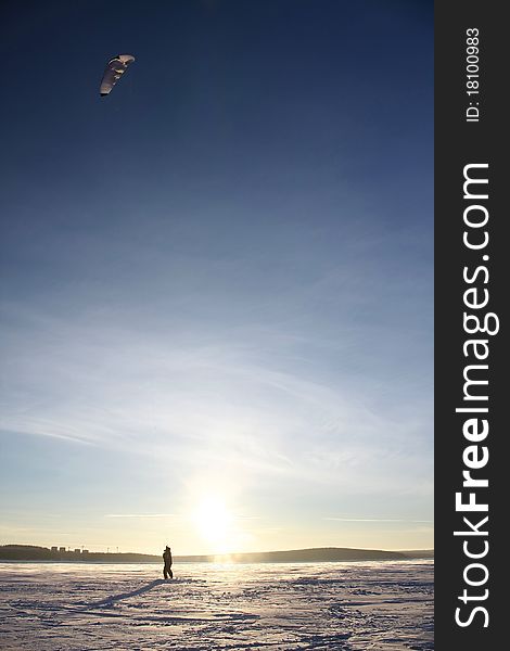 Paraglider silhouette sundown blue sky background