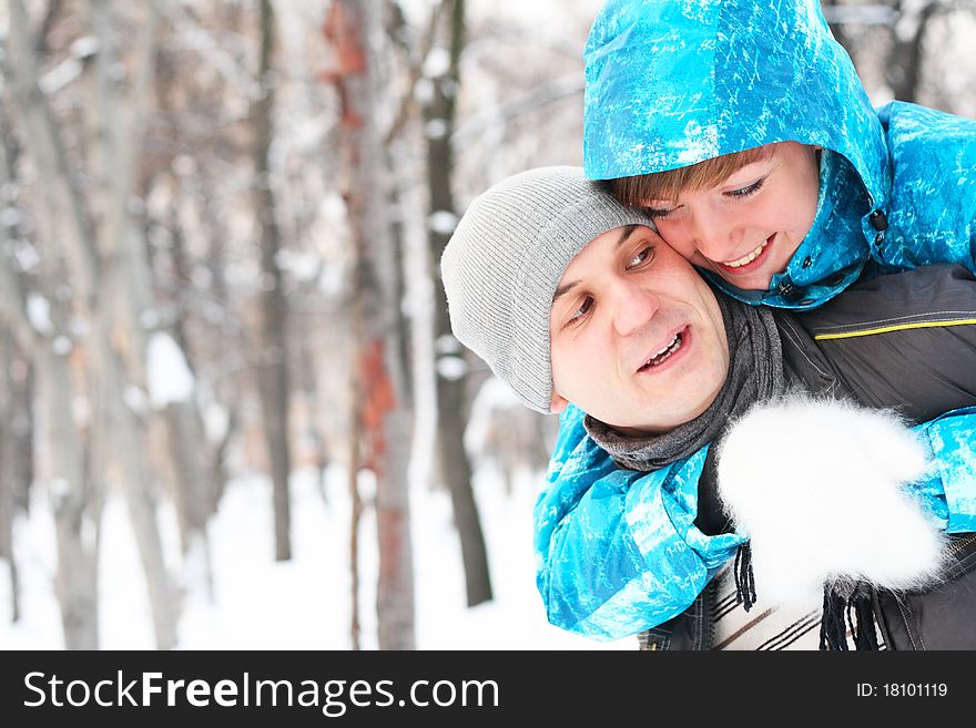 Young playful couple has a fun. winter