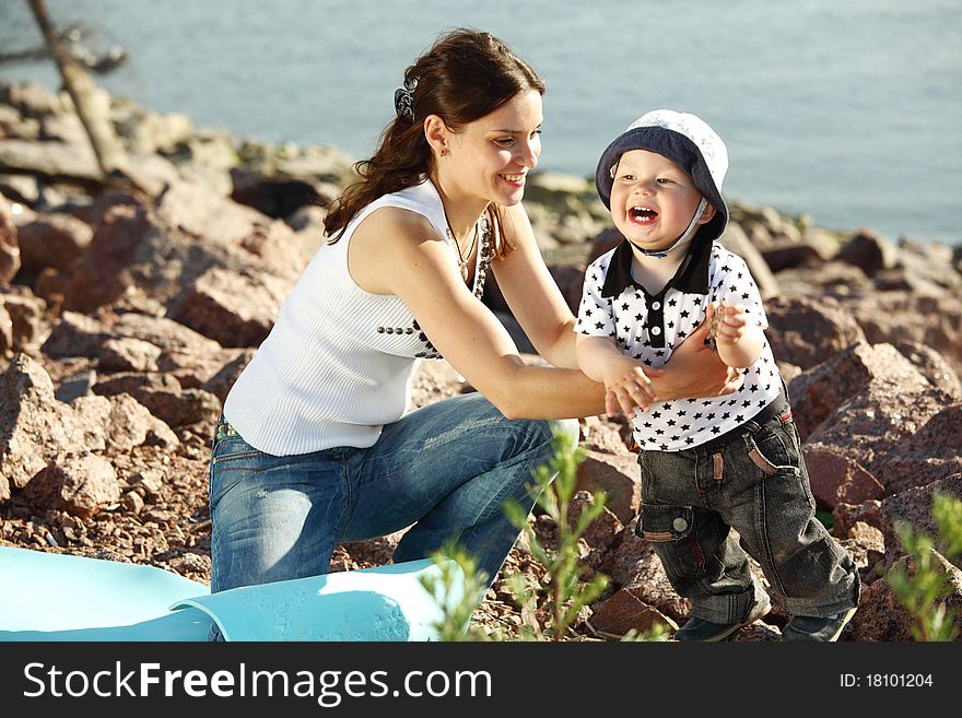 Happy mother and son on picnic near sea