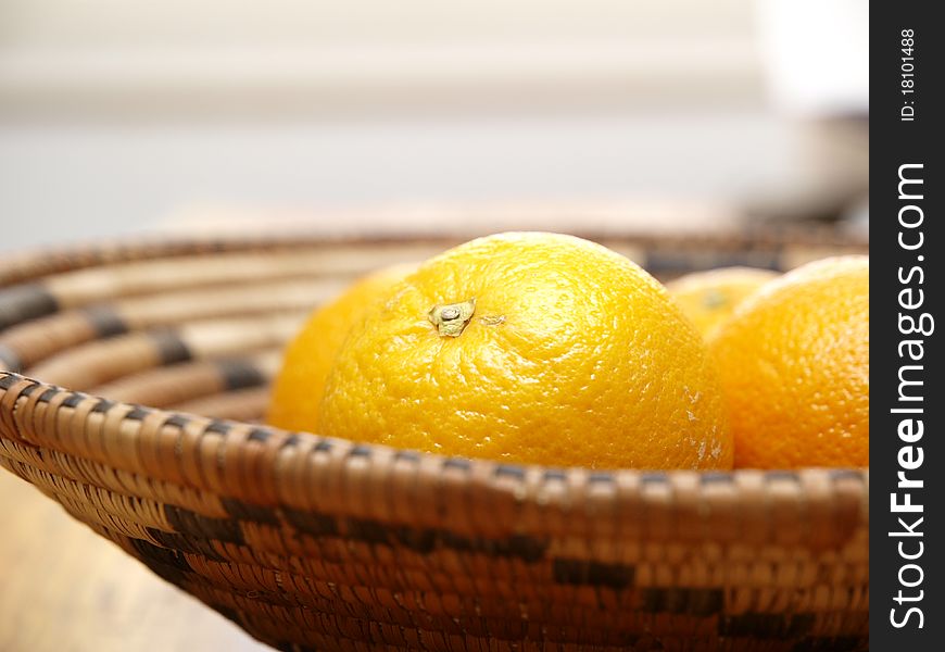 Oranges in a basket view from the side