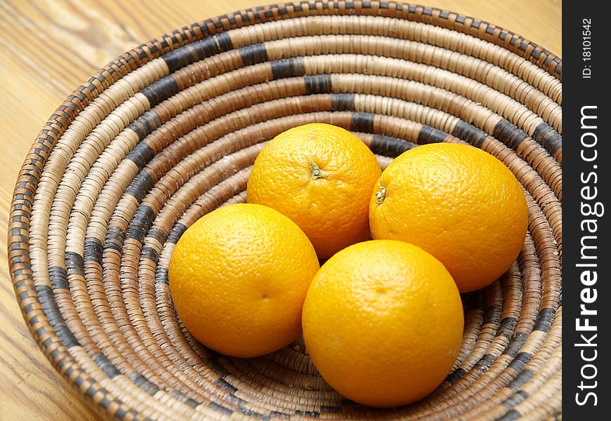 Four oranges in a basket